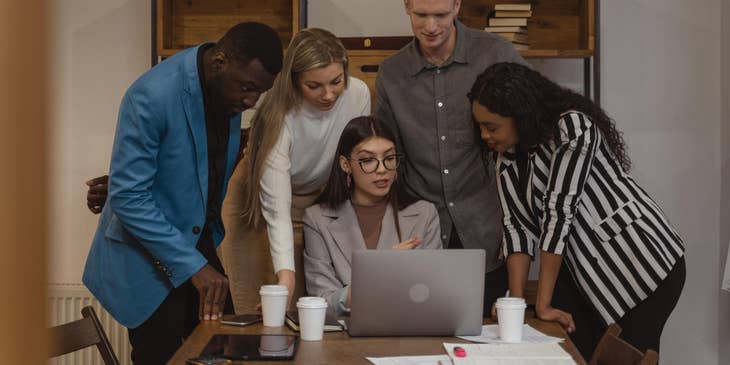 Marketing Executive gathering her teammates to provide ideas for their project