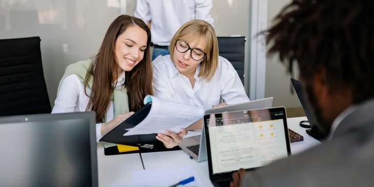A marketing specialist in a meeting conducting market research with her team.