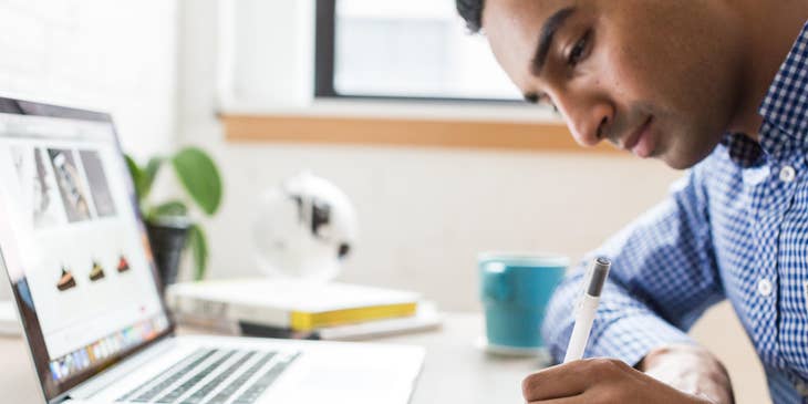 Marketing Strategist conducting market research while taking key notes