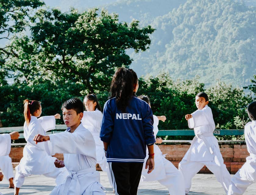 Martial arts instructor teaching a group of young students.