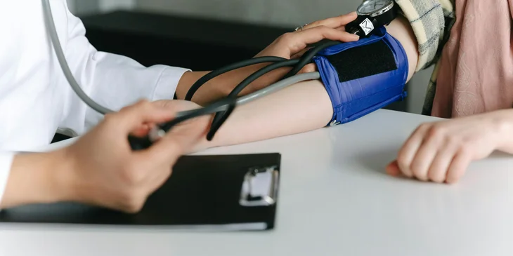 An MDS nurse monitoring a patient's blood pressure.