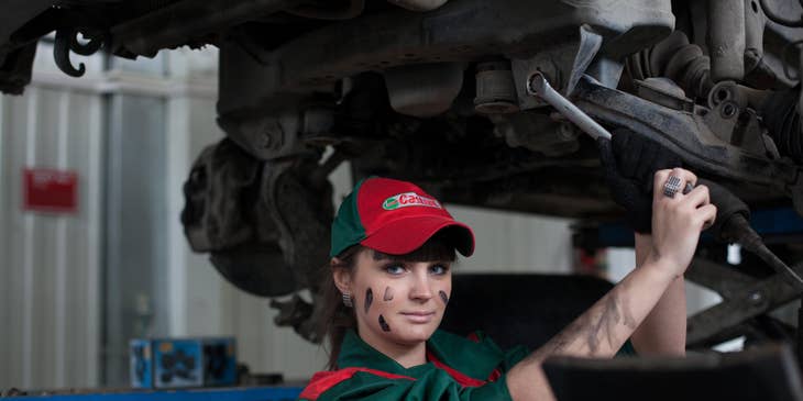 Mechanic apprentice holding a steel wrench