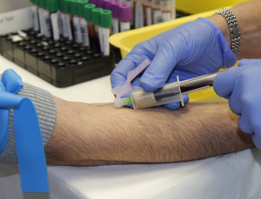 Med tech collects blood for analysis.