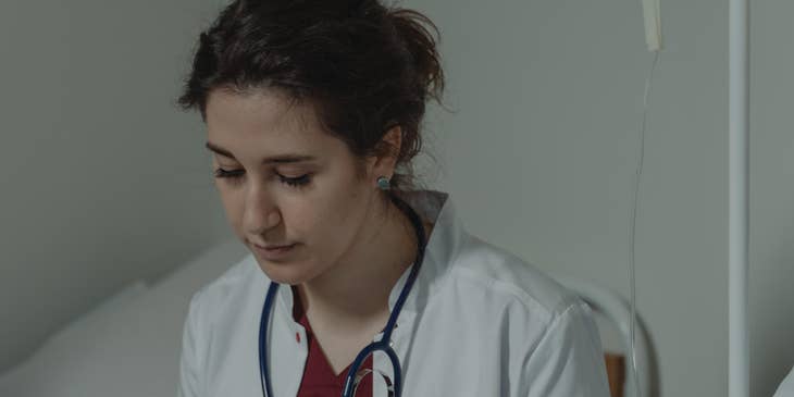 Medical assistant obtaining and recording patients' medical history.