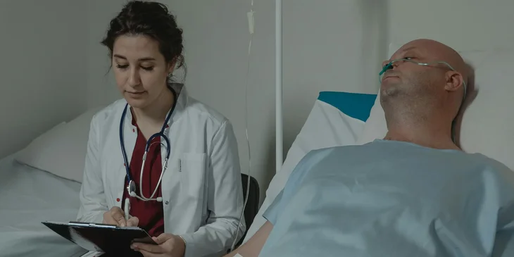 A medical assistant obtaining and recording patients' medical history.