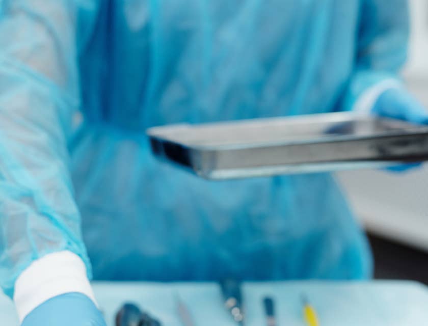 Medical equipment preparer assembling the instrument tray before a surgery.