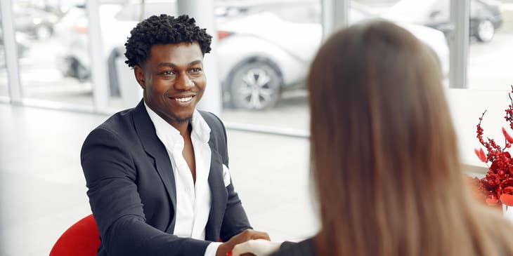 Member service representative shaking the hands of a newly signed up member of the club