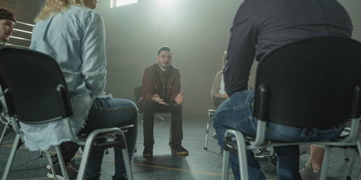 Mental Health Therapist facilitates a group therapy session.