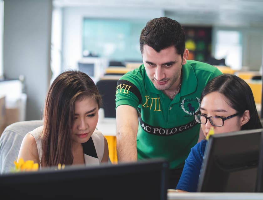 A team of mobile developers deliberating on the new system design as part of their team's project.