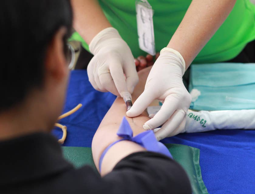 Mobile phlebotomist extracting blood samples using clean needles.