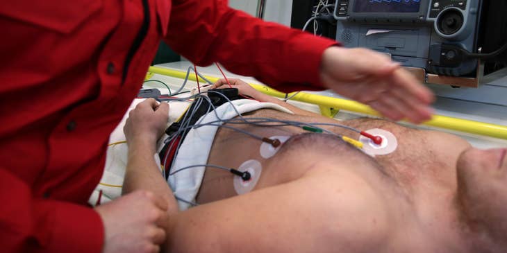 Monitor technician attaching electrodes to the patients' bodies.