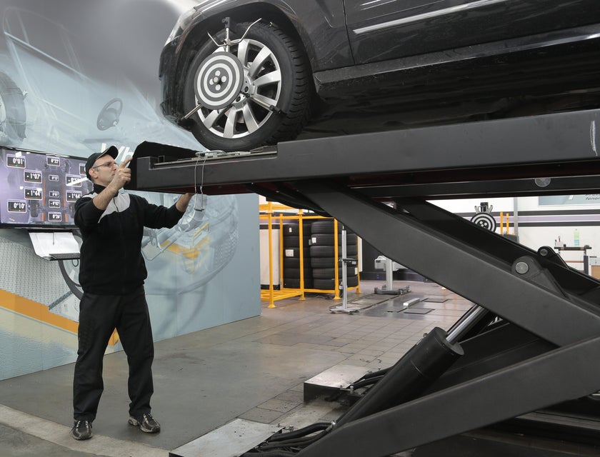 MOT tester checking on a black sedan