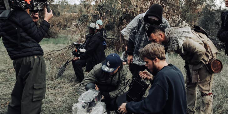 The director and movie producer checking the footage from a movie set.