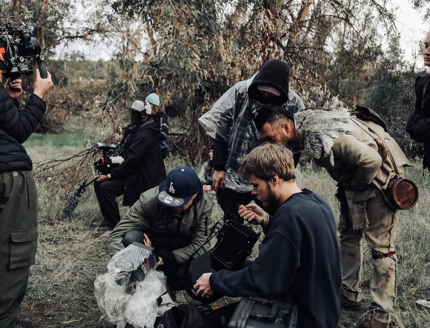 The director and movie producer checking the footage from a movie set.