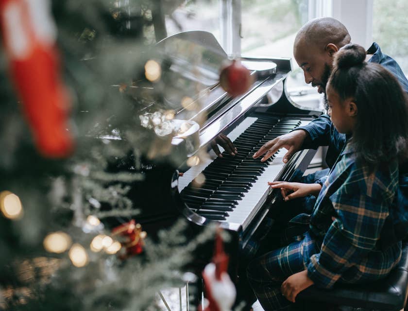 Music teacher teaches a student in playing piano for a Christmas play
