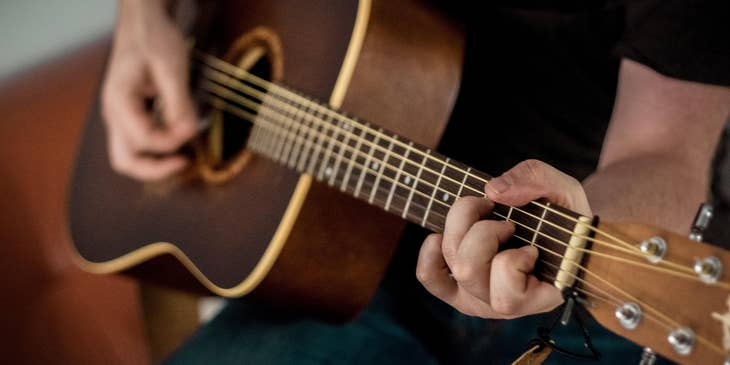 Music therapist providing music therapy sessions by playing the guitar.