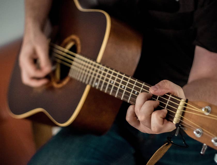 Music therapist providing music therapy sessions by playing the guitar.