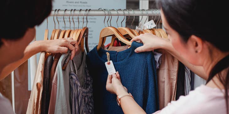 Mystery shopper inspecting the product and asking the Store Rep about the clothes to test her customer service skill