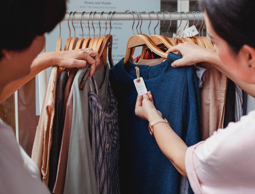 Mystery shopper inspecting the product and asking the Store Rep about the clothes to test her customer service skill