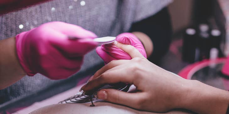 Nail technician doing a manicure on a client