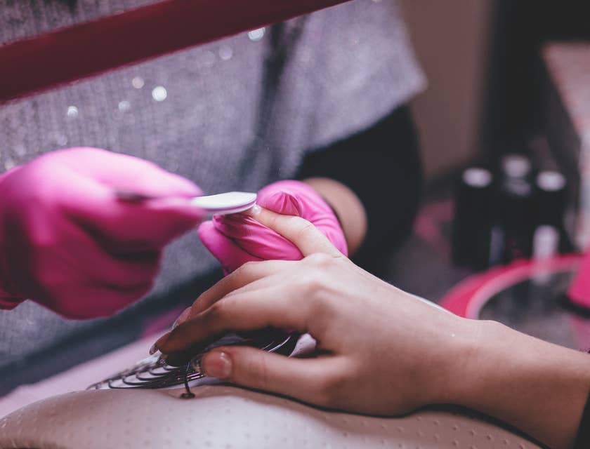 Nail technician doing a manicure on a client