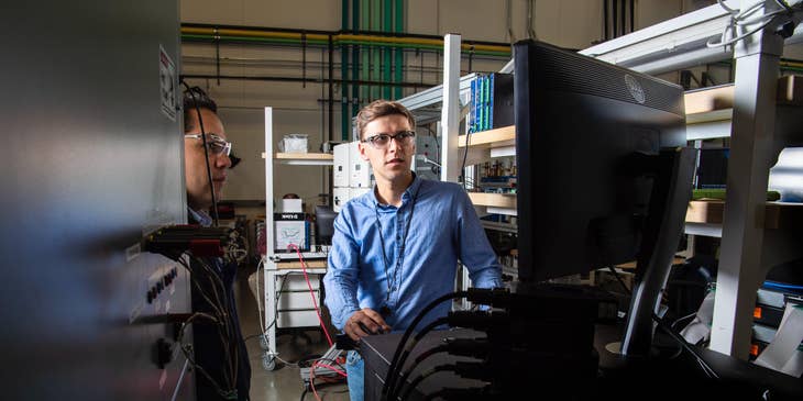 Two network engineers doing a maintenance check on the company's computer network