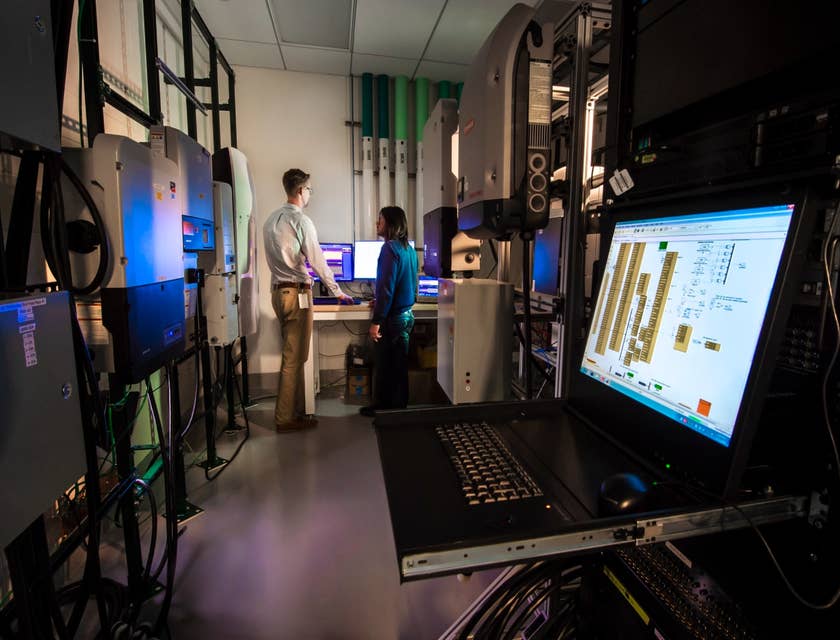 female Network Specialist getting the network's performance results with her colleague standing beside her