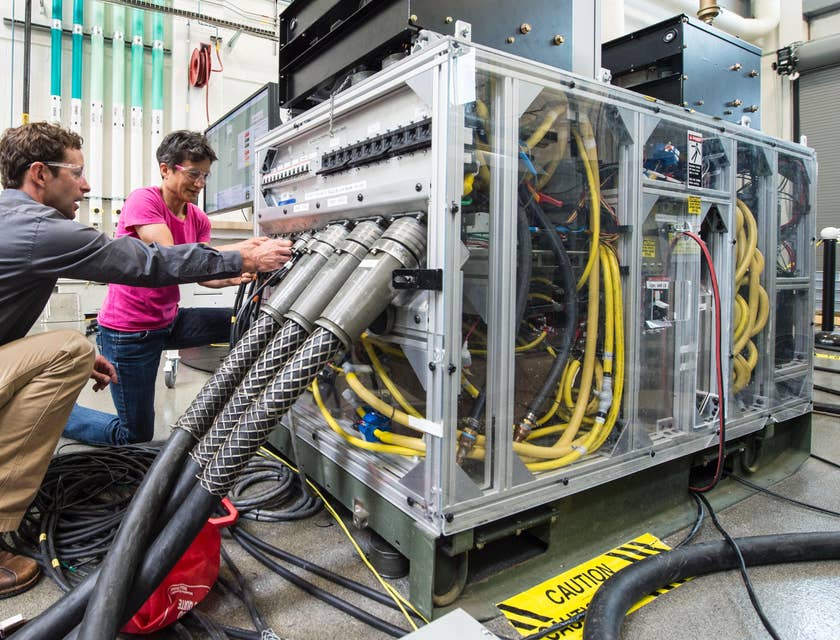 Network support technicians managing the cables of one of the company's servers