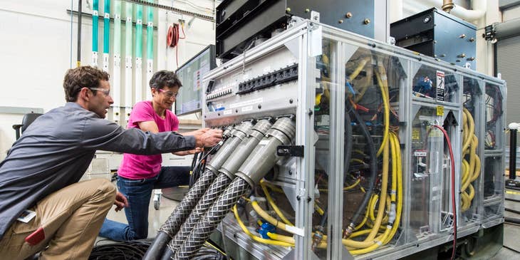 Network support technicians managing the cables of one of the company's servers