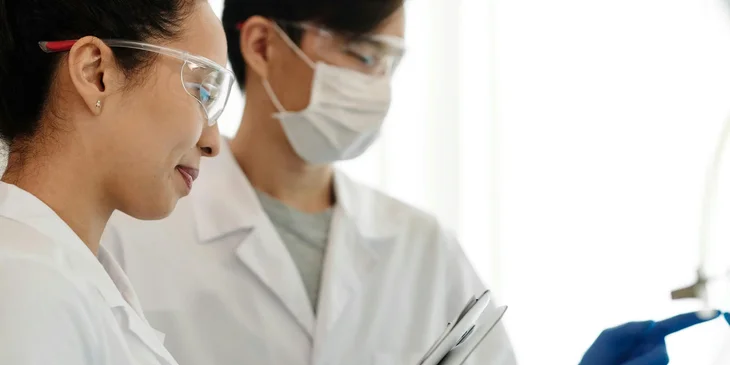 A neuroscientist leading assistants in clinical work.