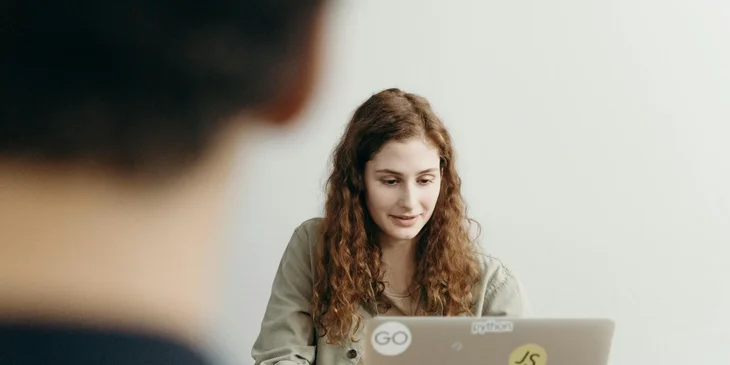 A Node.js developer working on a laptop.