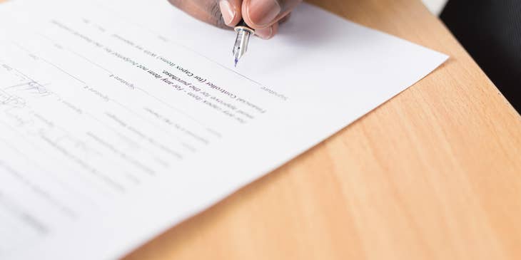 A man signing noncompete agreement.