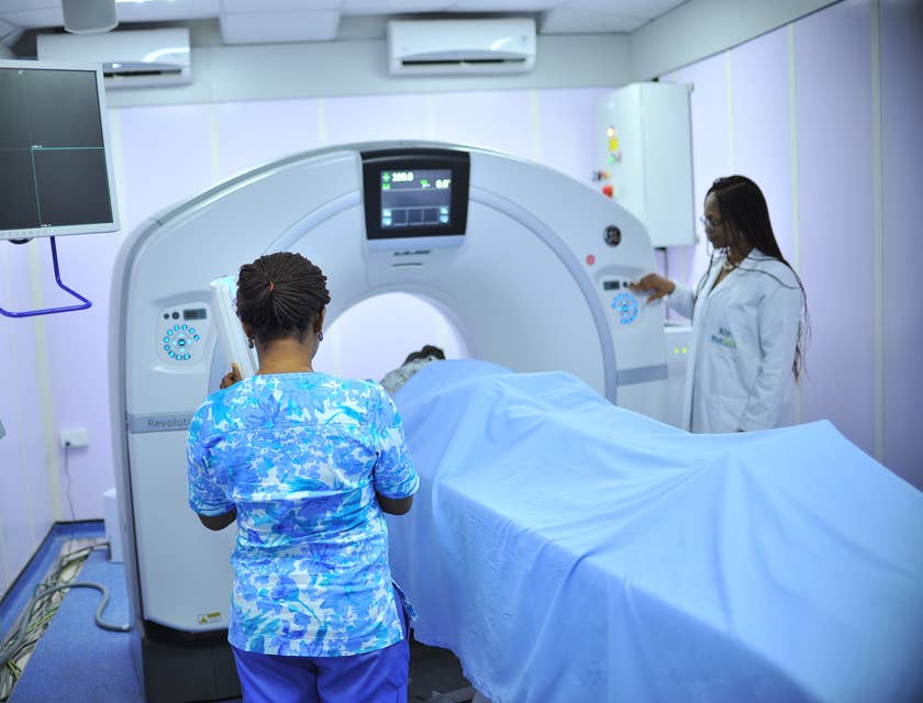 Nuclear medicine technologist operating imaging equipment.