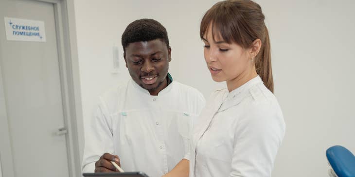 The nurse manager orients the new staff member.
