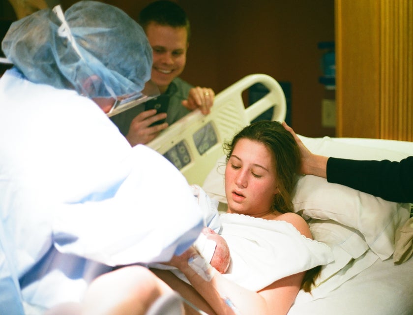 Nurse midwife assists during labor and delivery.