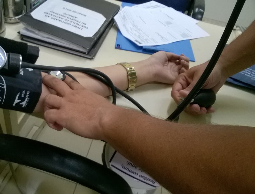 Nursing assistant taking patients' blood pressure.