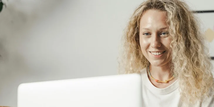 A female onboarding specialist working on her laptop.