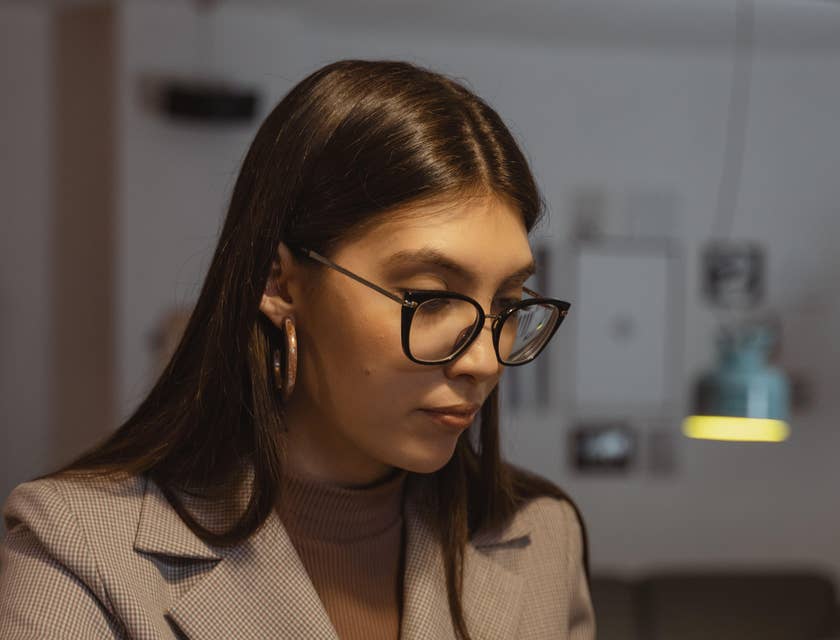 A female onboarding specialist working on her laptop.