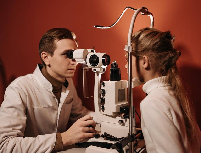 Ophthalmologist performing a vision testing on a young girl.