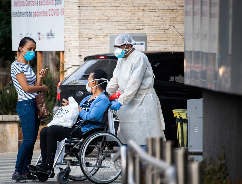 Orderly attendant pushing a wheelchair of a discharged patient.