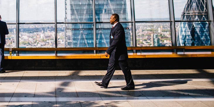 Man walking past glass window