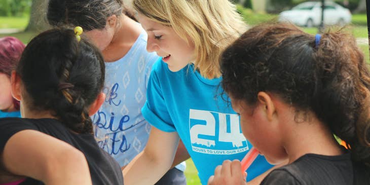 Female outreach coordinator serving as a volunteer on a community event.