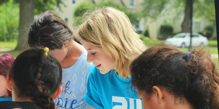 female outreach coordinator serving as a volunteer on a community event