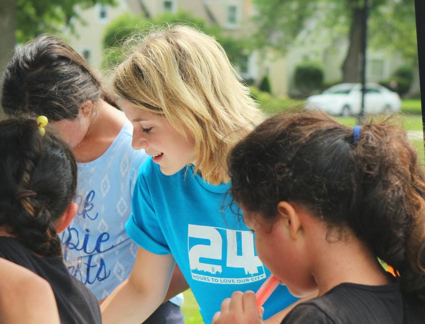 female outreach coordinator serving as a volunteer on a community event