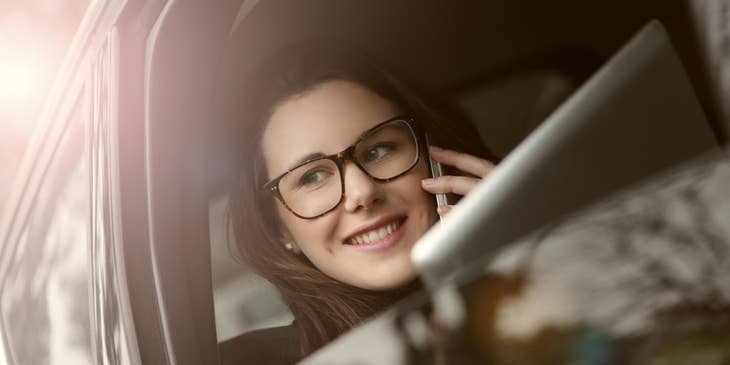 Outside sales representative on the way to meet a new client she's talking on the phone.