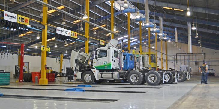 Owner operator talking to the mechanic to check for the truck before loading the cargo