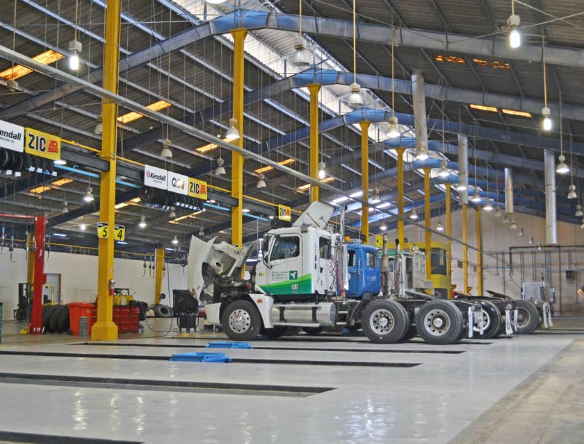 Owner operator talking to the mechanic to check for the truck before loading the cargo