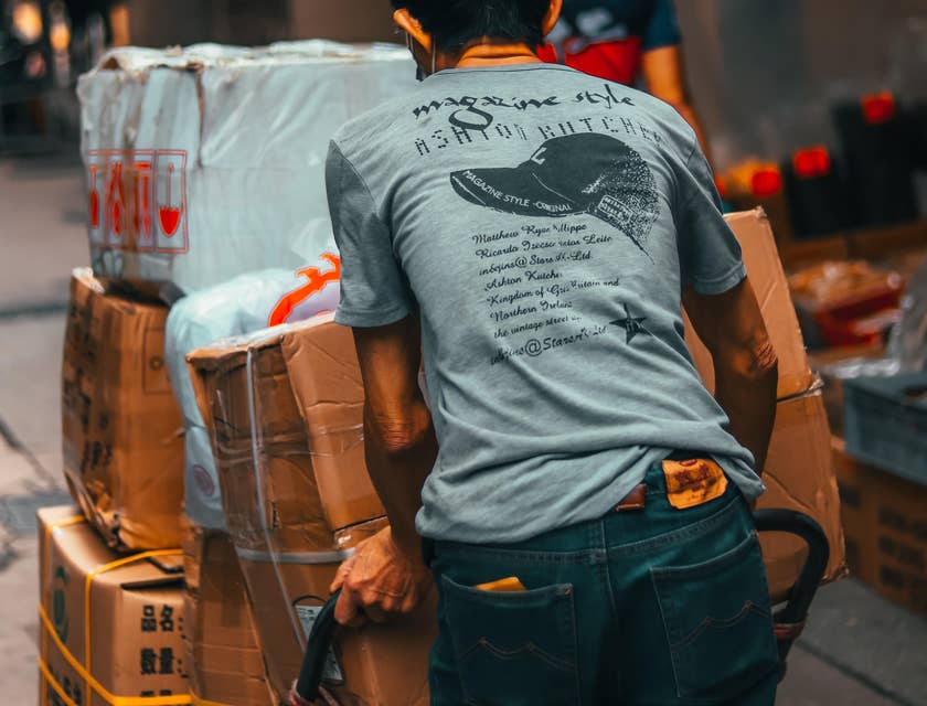 Package handler on the way to load the parcels into the truck
