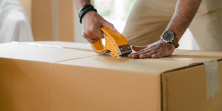 Packager packaging the item, making sure it's properly sealed before storing.