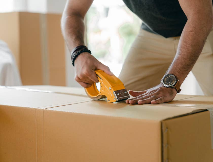 Packager packaging the item, making sure it's properly sealed before storing.